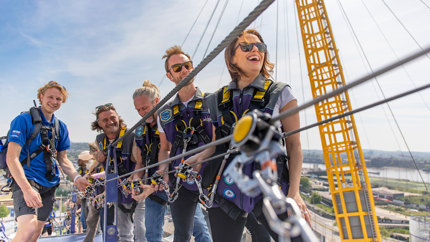A group of six climbers stood smiling at the top of the O2 arena