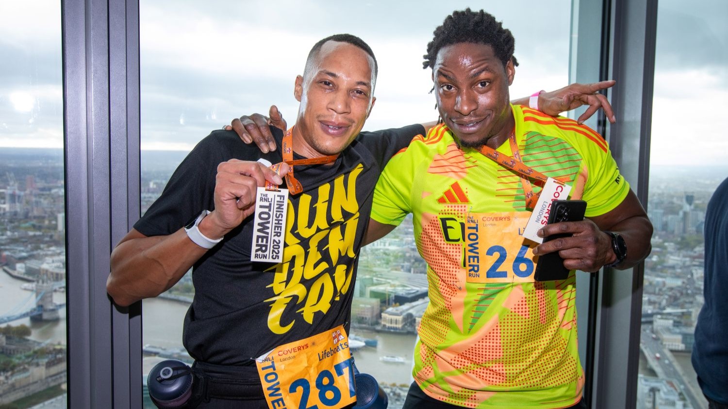 Participants of the RNLI Tower Run holding up their medals
